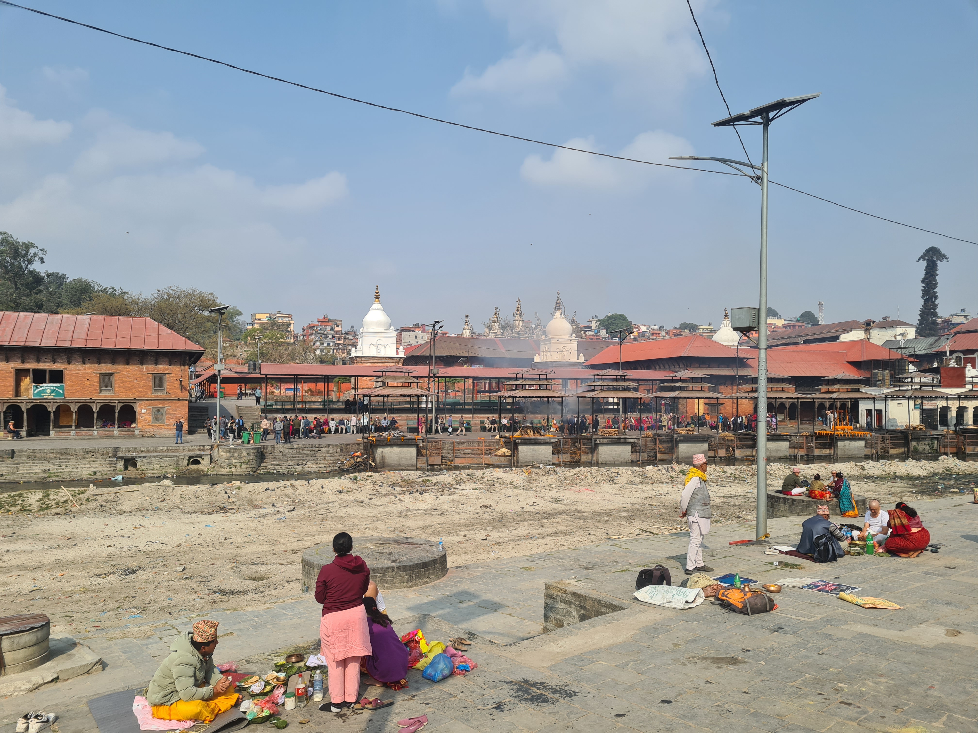 People standing in a dirt area with people in the background

AI-generated content may be incorrect.