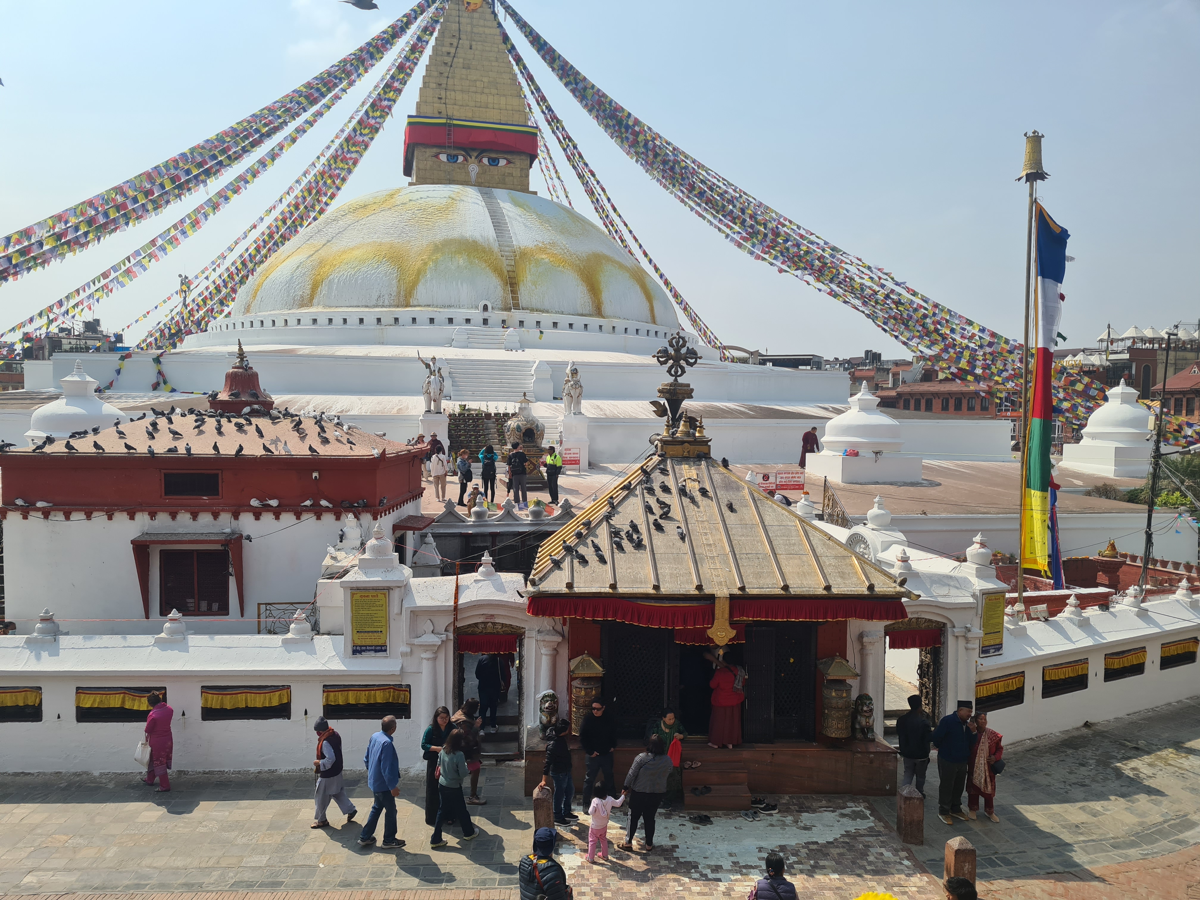 A group of people walking in front of Boudhanath

AI-generated content may be incorrect.
