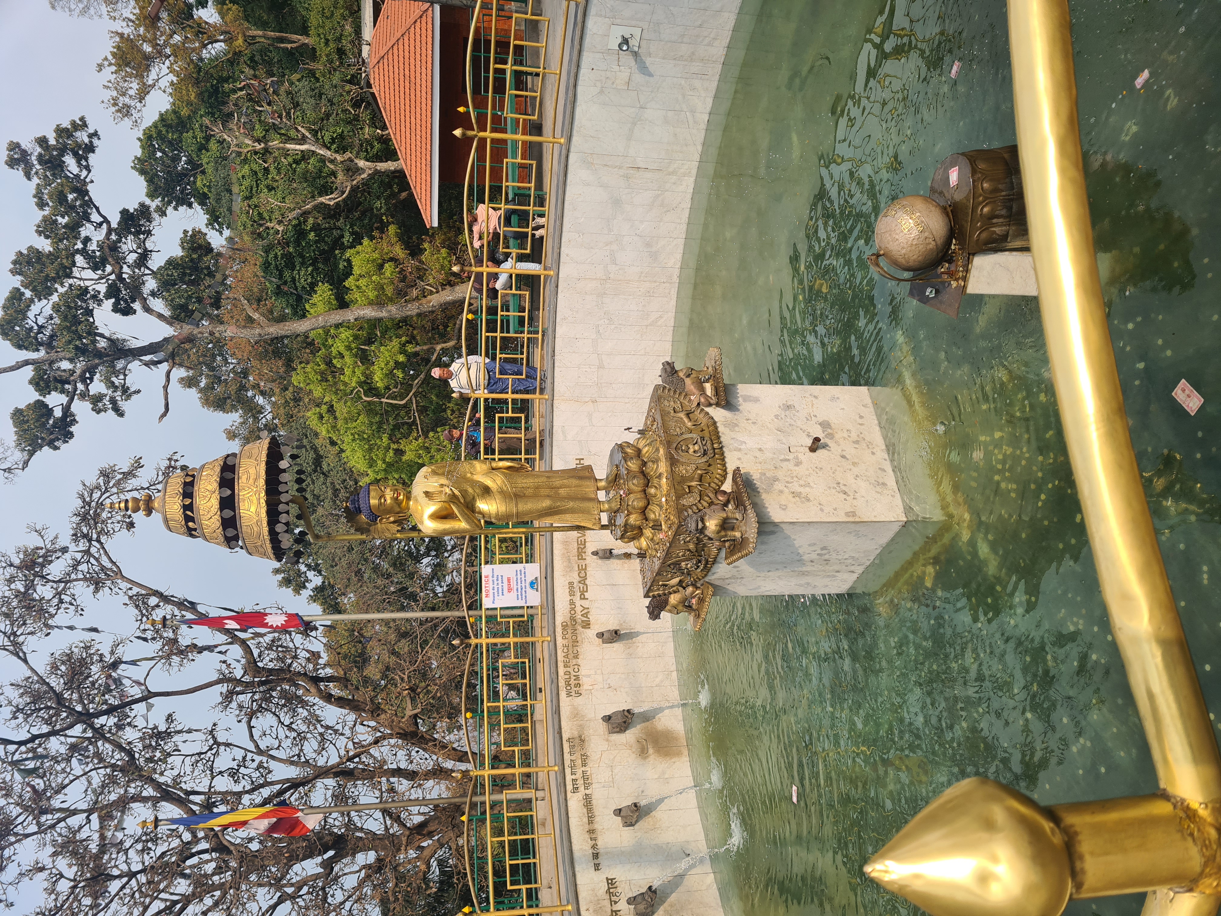 A gold statue in a fountain

AI-generated content may be incorrect.